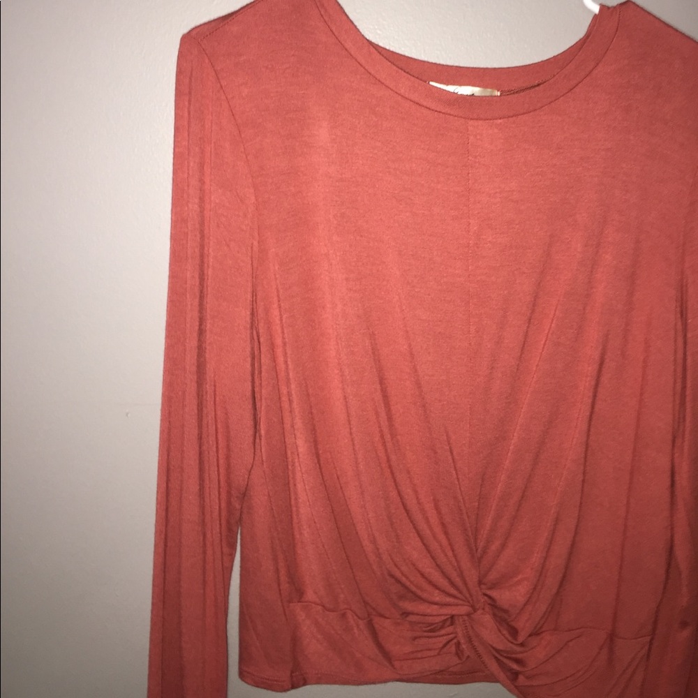 Tan pink tunic folded shirt.